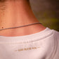 Rückseite eines cremeweißen Sweatshirts mit goldenem GOD BLESS YOU Druck im Nackenbereich.